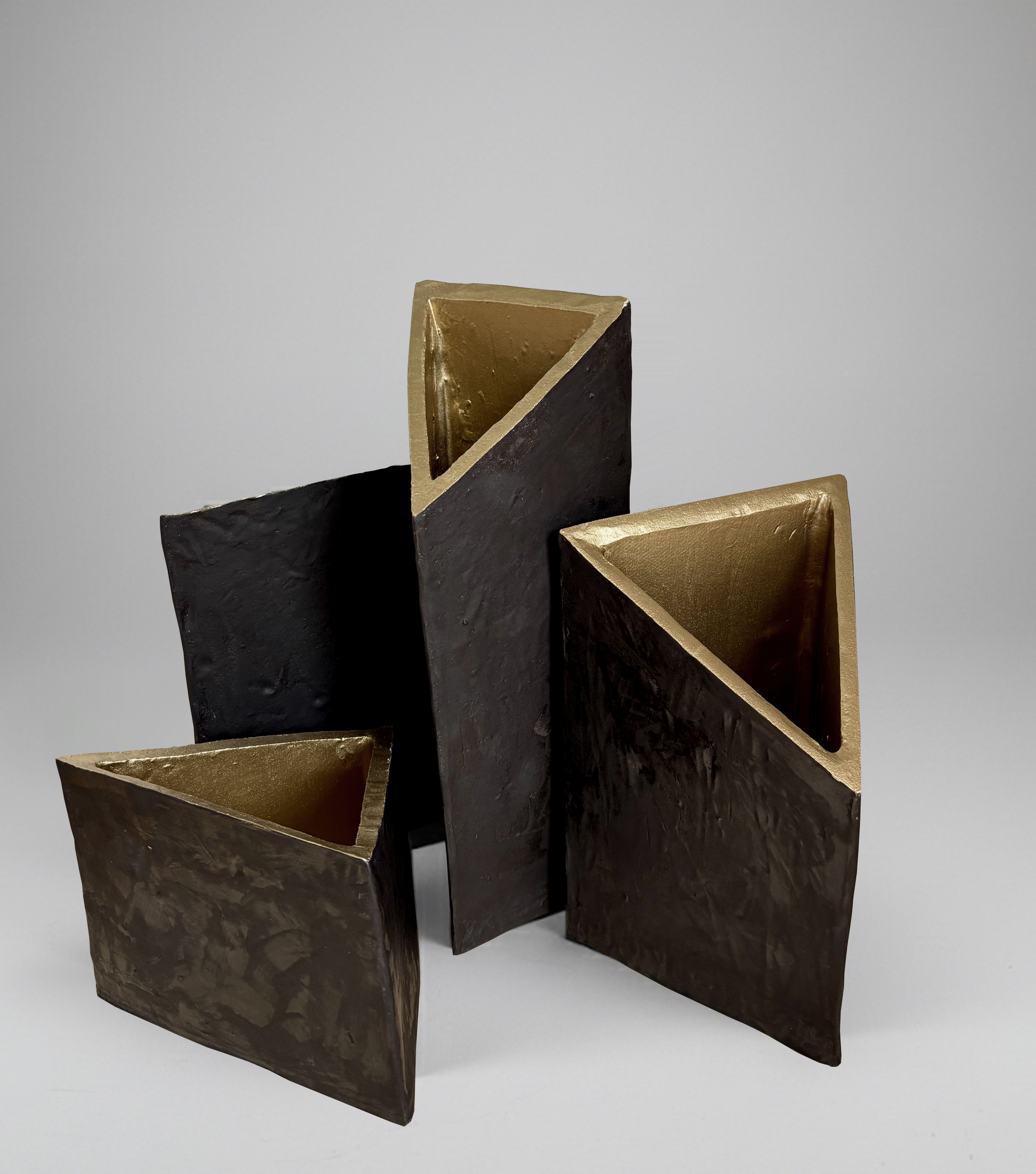 Sculptural series of black ceramic vases with gilded engobe interior
Installation dimensions: 43 × 47 cm