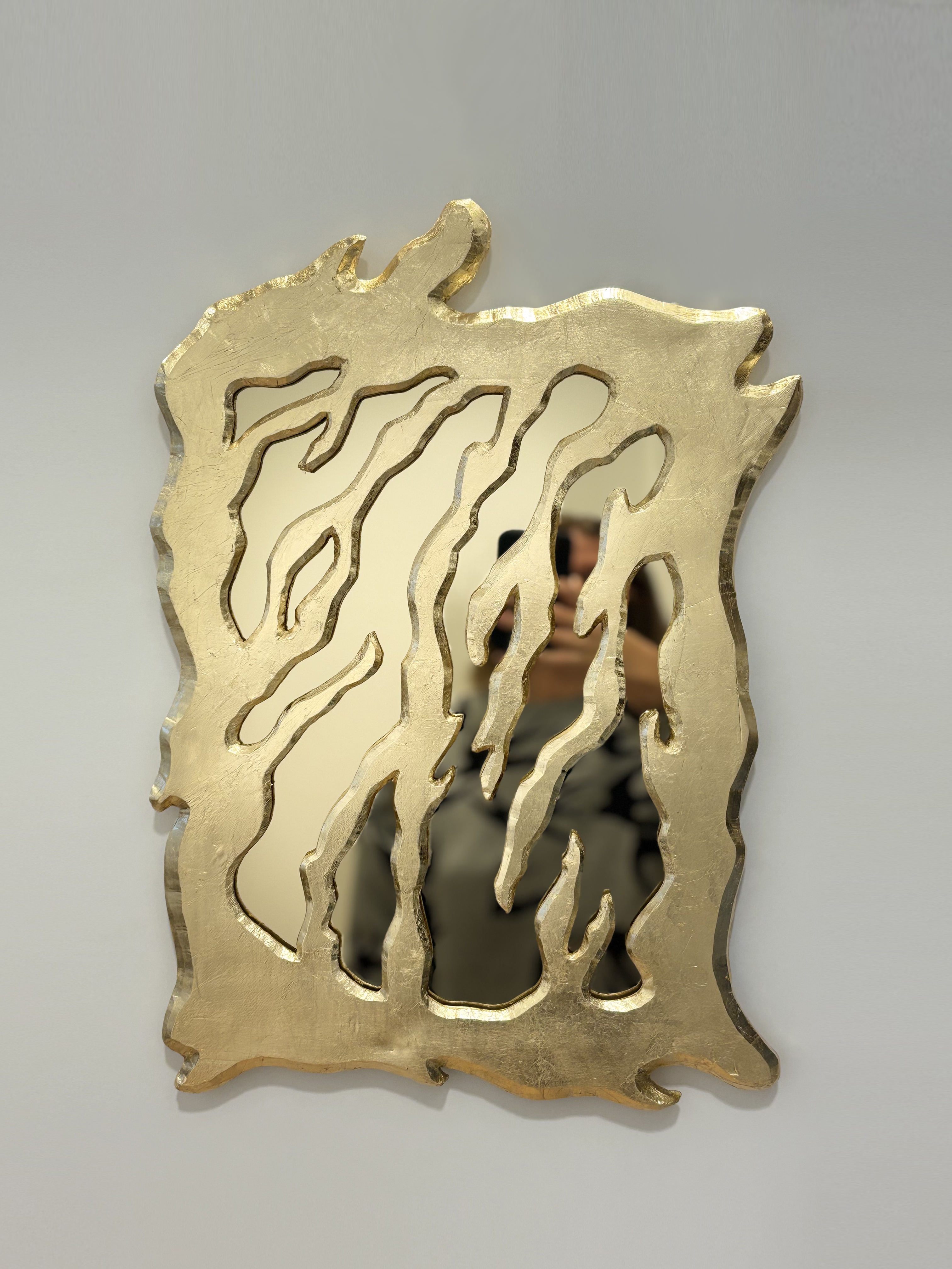 Sculptural ceramic mirror with gold-leaf finish and golden plexiglass pane, 53x35 cm